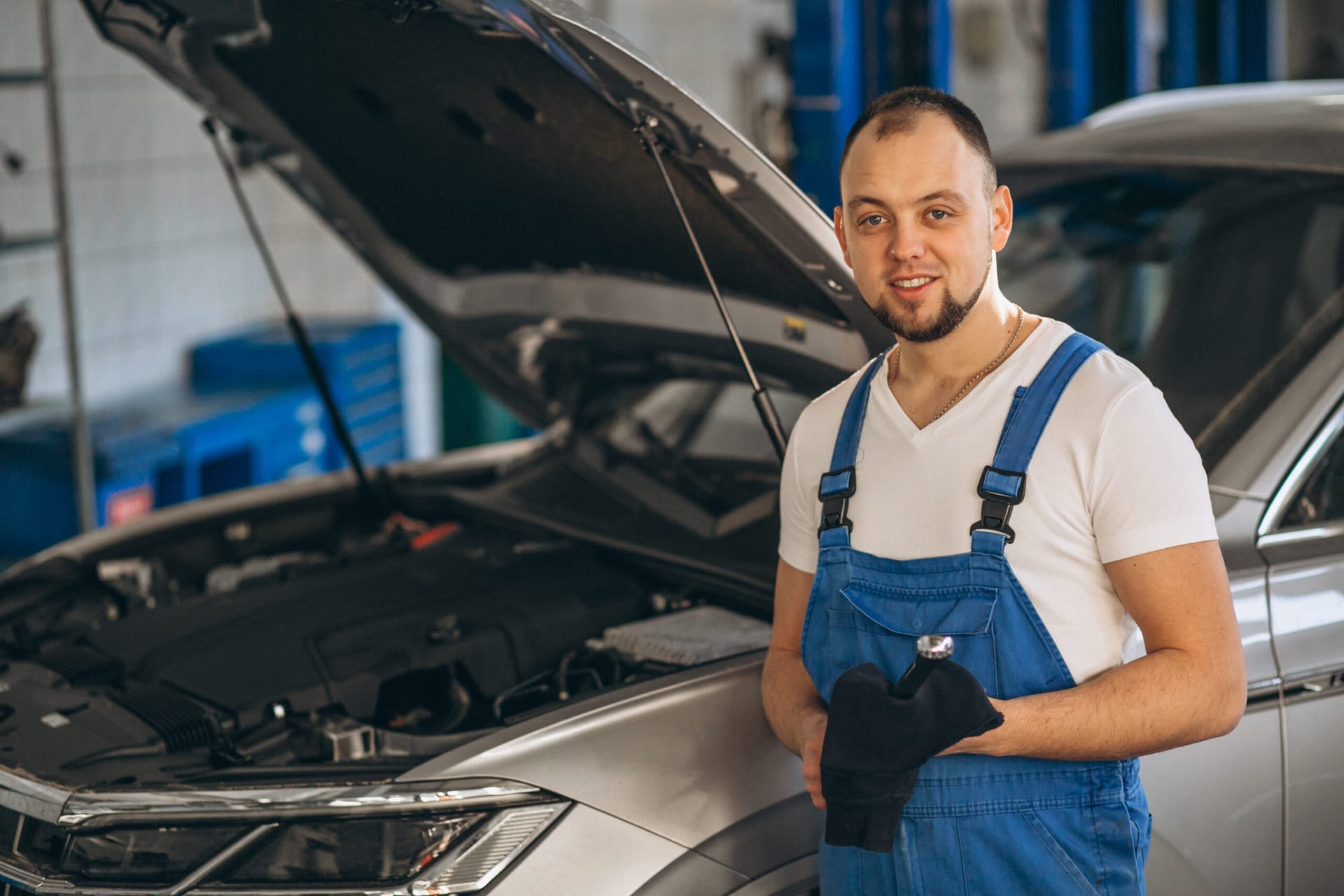 Auto mechanic checking car